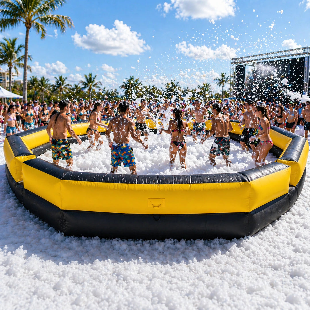 Group of people playing in a foam pit on a sunny day with palm trees in the background