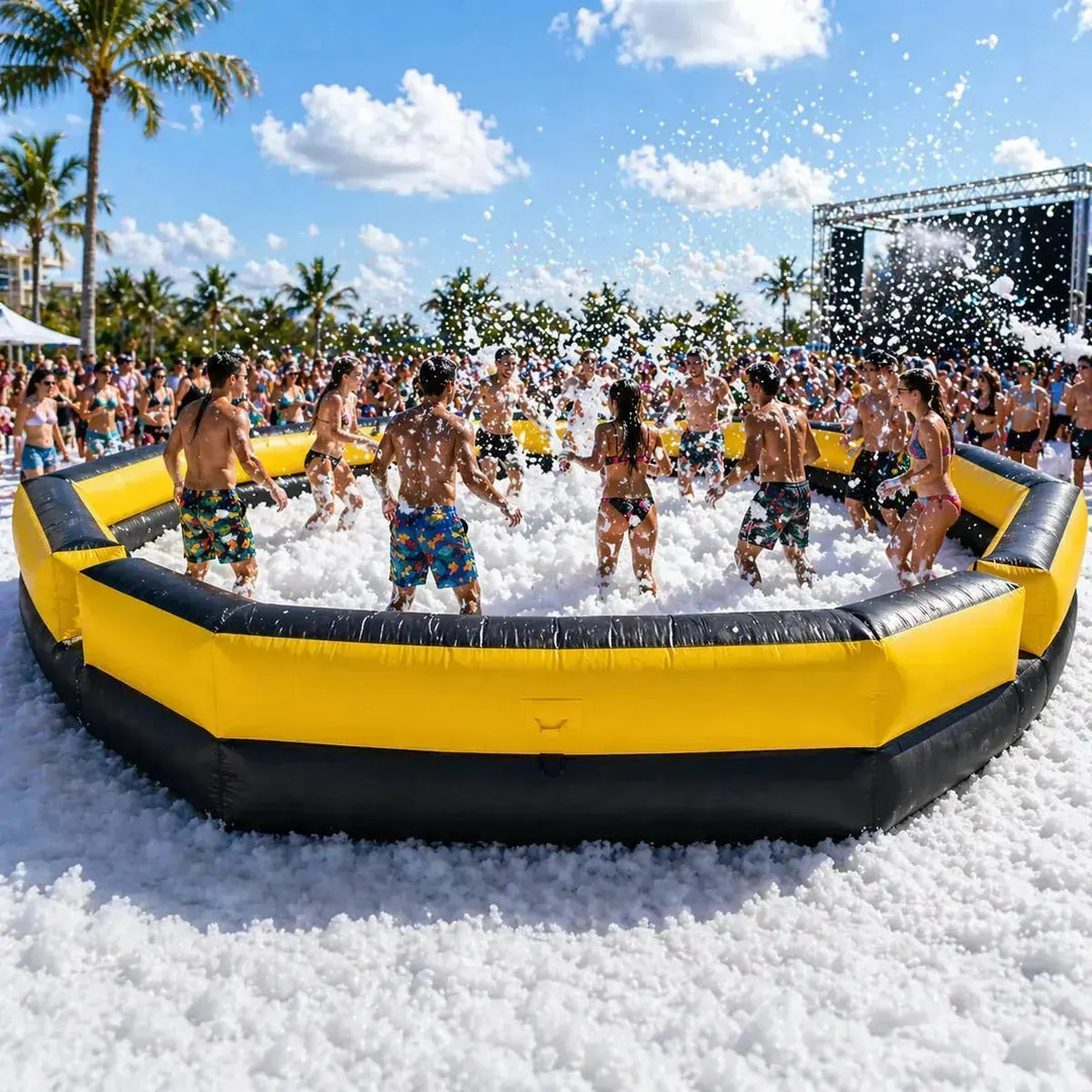 Group of people playing in a foam pit on a sunny day with palm trees in the background