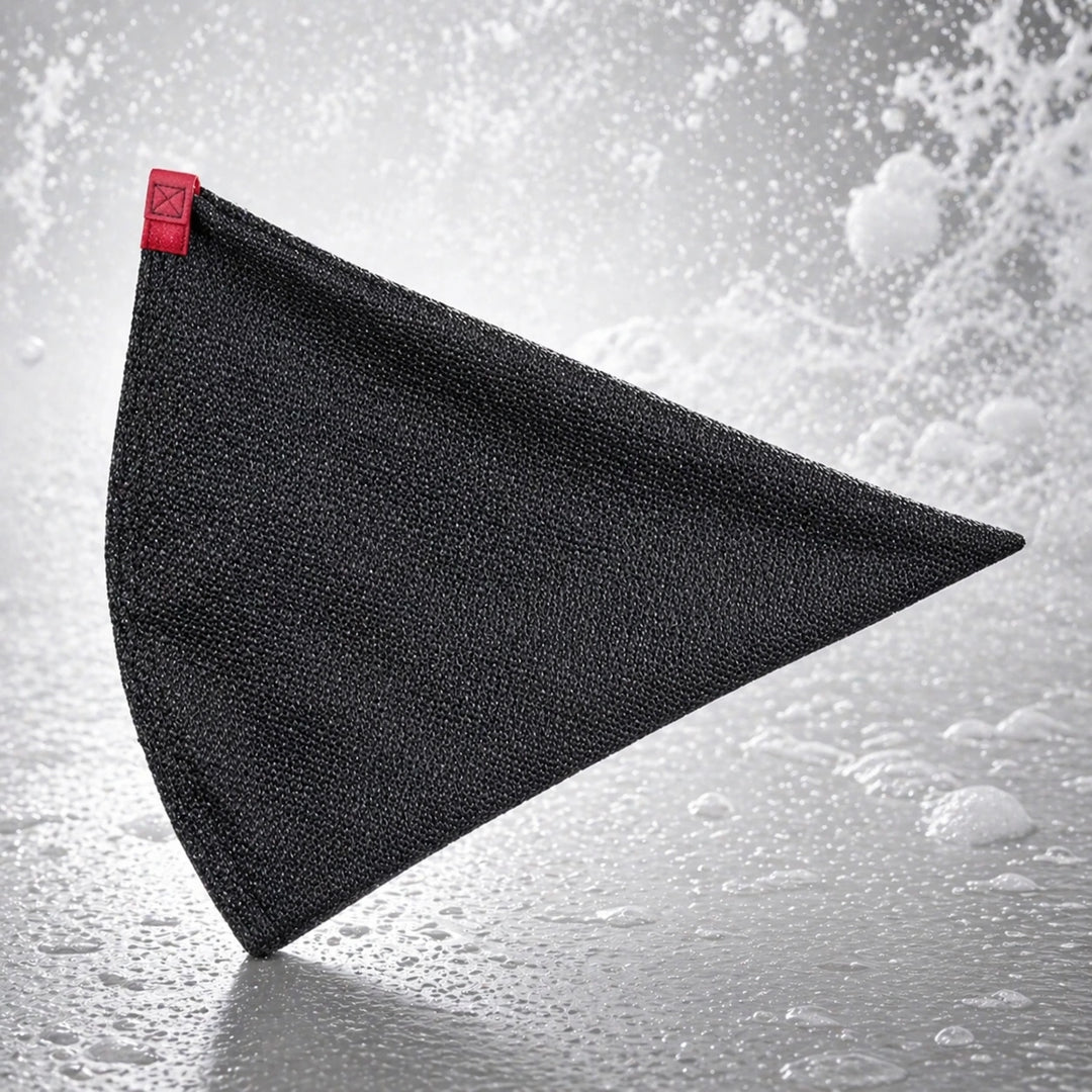 Black triangular towel with a red clip on a gray background